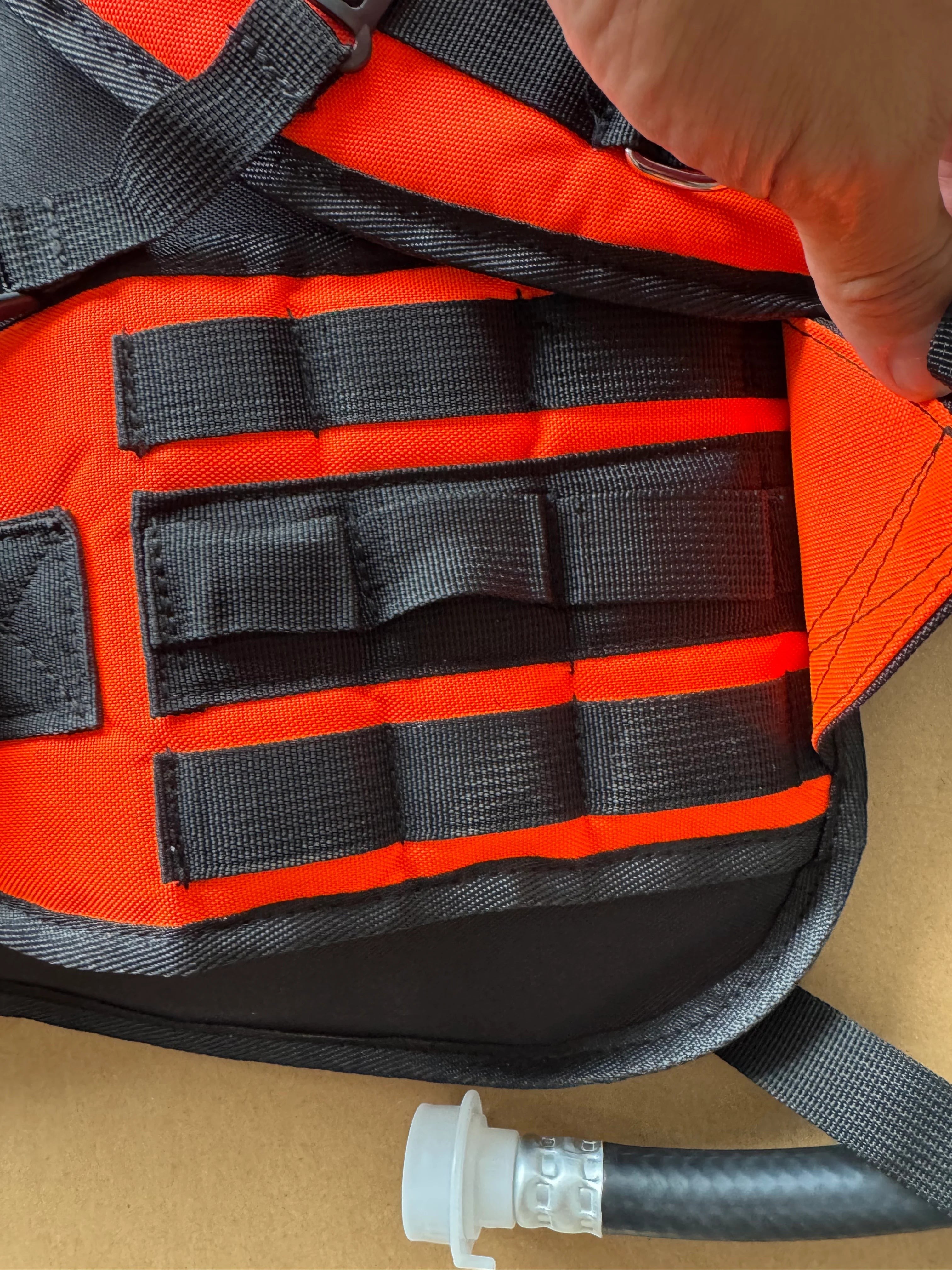 Detalle de correas MOLLE en mochila extintora GERF SAFETY de color rojo y negro fabricada en resistente Cordura 1000D.
